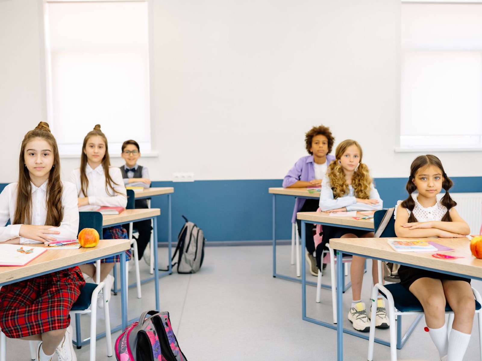 A multi-ethnic group of school students seated at their desks during a lesson