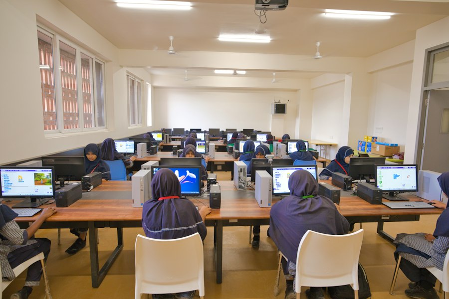A full class working at desktop computers in a school computer lab